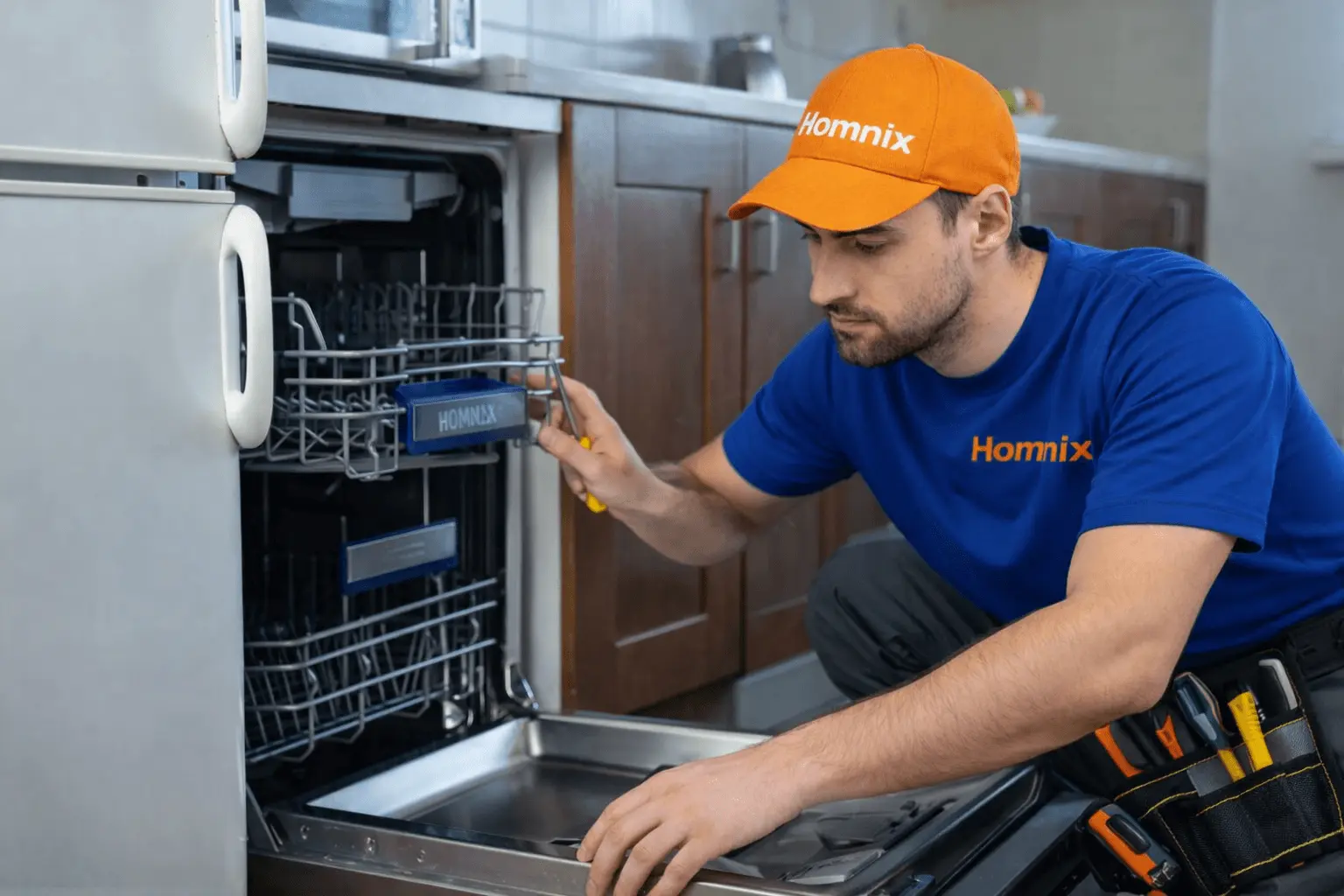 Best Dishwasher Repair in Moncton | Homnix Trusted Service Technician repairing a dishwasher in kitchen